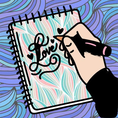 a hand writing “love” in calligraphy on a notebook