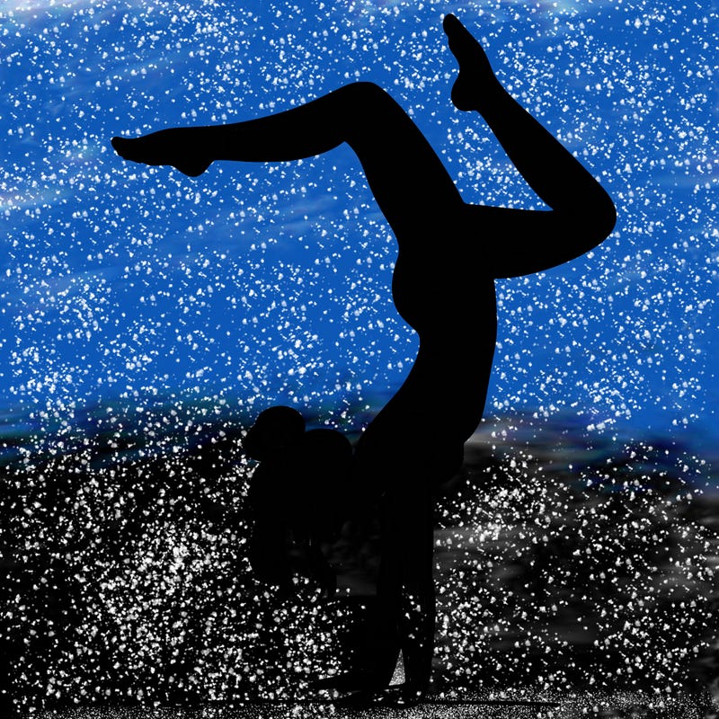 a woman doing a handstand