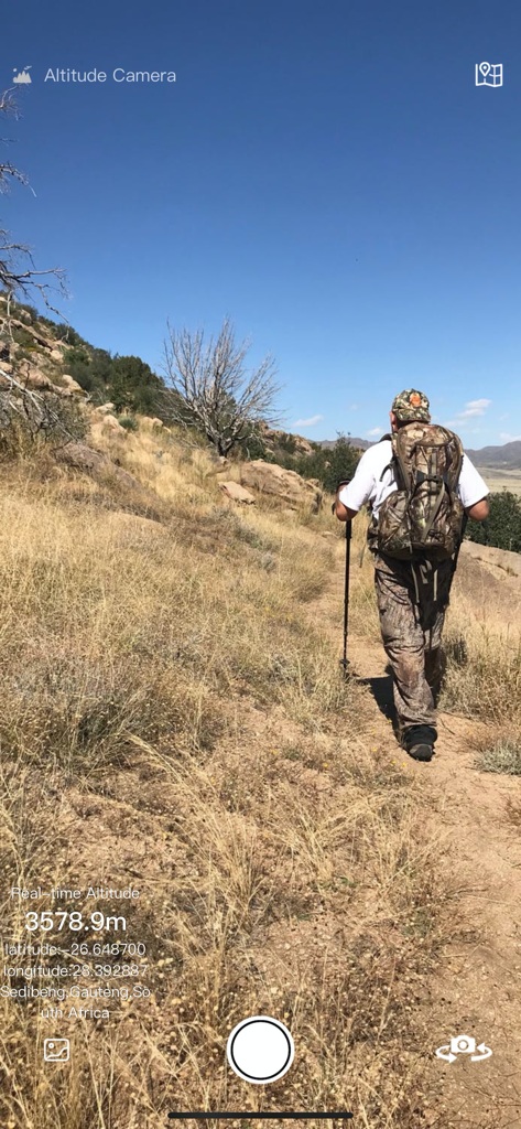 Altitude Camera app interface capturing a hiker with real-time altitude and GPS location data overlay.
