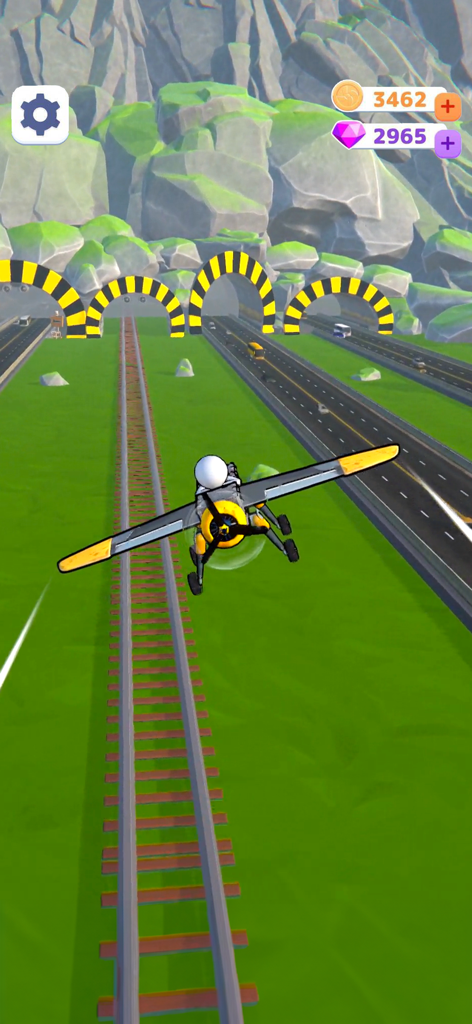 Un avión de hélice personalizado volando sobre un paisaje con ferrocarriles y autopistas hacia túneles de carretera.