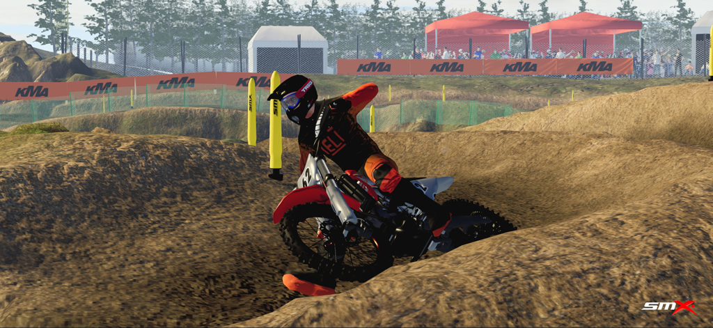 A motocross rider performing a turn on a realistic dirt track in the SMX mobile game