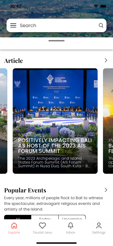 The explore screen of the Love Bali app showing travel articles and a list of popular events