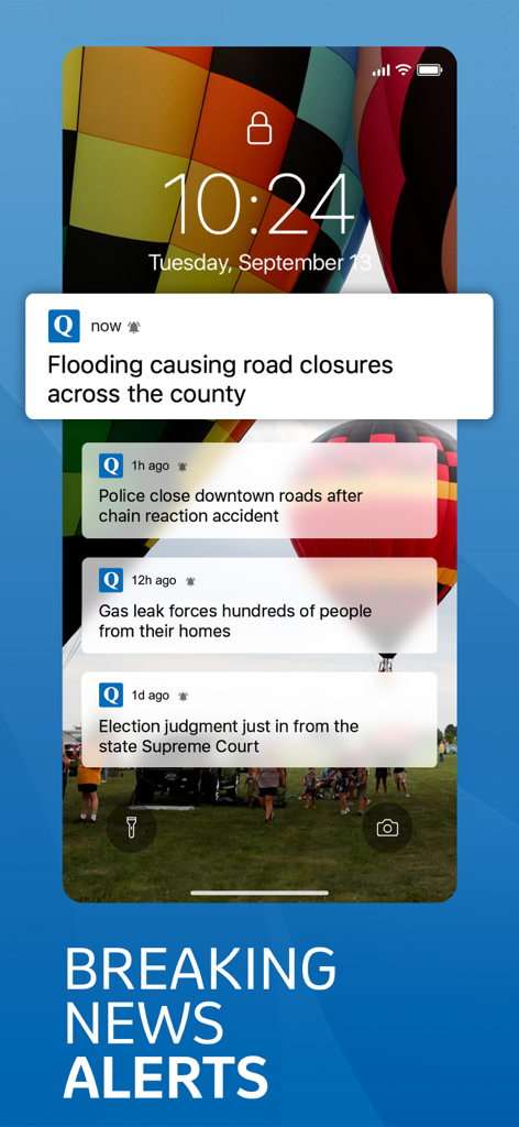 QCTimes - iPhone lock screen showing breaking news notifications from the QCTimes app including local road closures and emergency alerts.