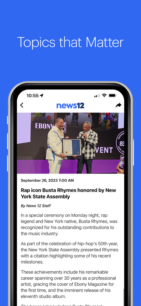 News 12 Mobile - A mobile screenshot of the News 12 app showing a local news article about Busta Rhymes being honored by the New York State Assembly.