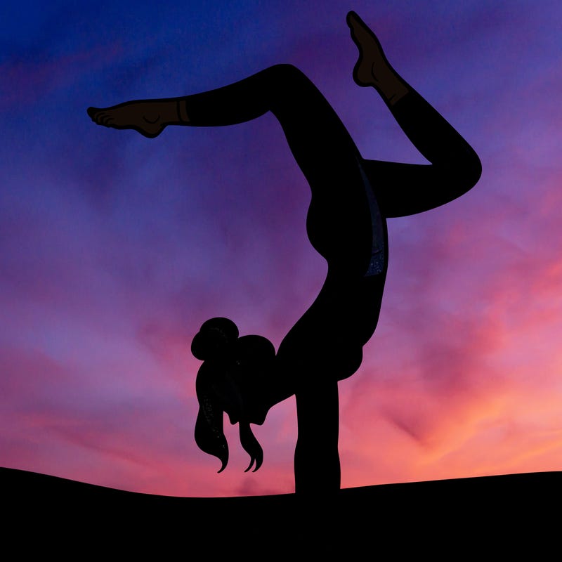 a woman doing a handstand