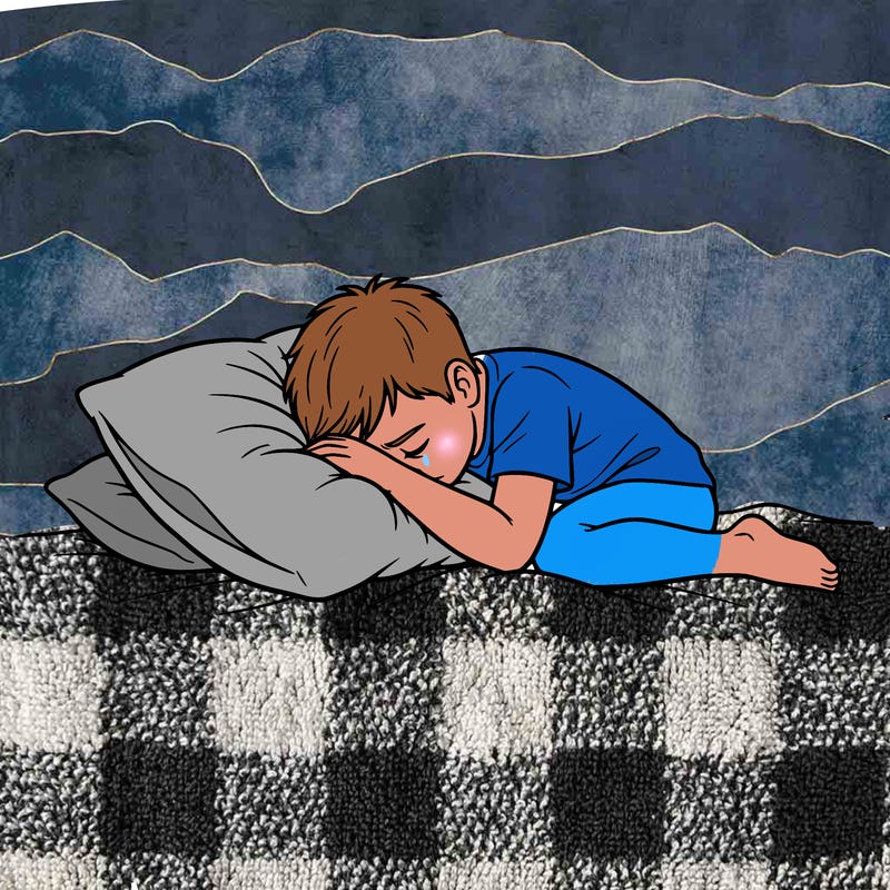 sad boy laying with head down on pillow