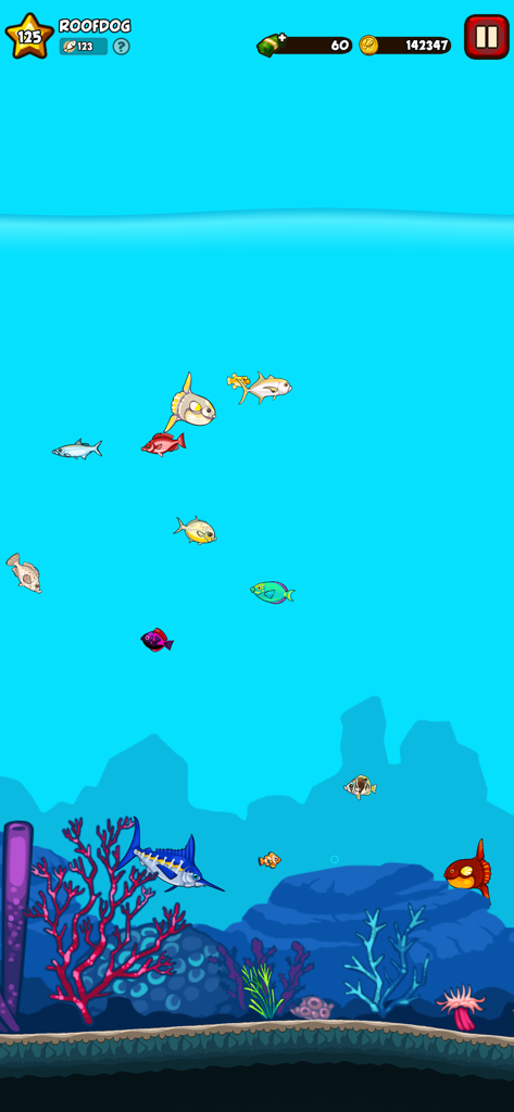 Fishing Break - Underwater gameplay scene from Fishing Break showing various colorful fish species swimming near a coral reef