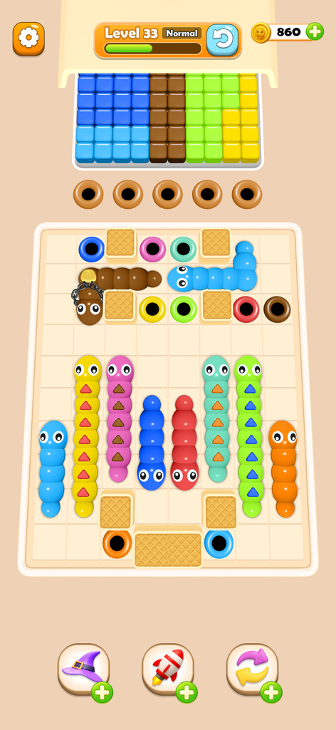 Worm Color Blast - Colorful squishy worms on a grid matching with color holes in a mobile puzzle game level.