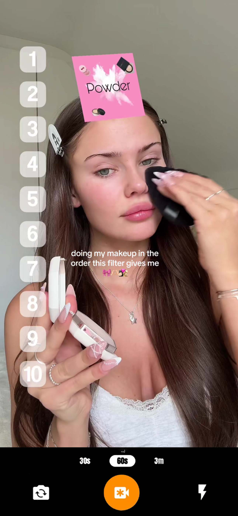 Ranking Filter Challenge Viral - A woman using the Ranking Filter app to do her makeup in a randomly generated order, showing a powder card above her head.
