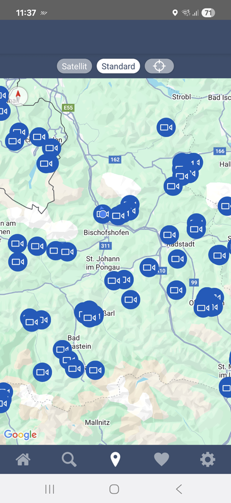 A map view displaying numerous blue webcam icons across a mountainous region for outdoor planning.