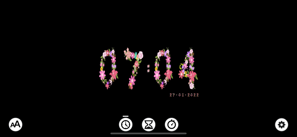 Digital clock display showing the time in a decorative floral font on a dark background.