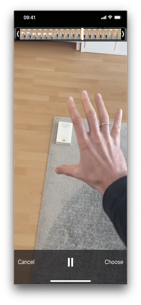 User interface of the Reverse Video Editor app showing a hand reaching for an object with video editing controls