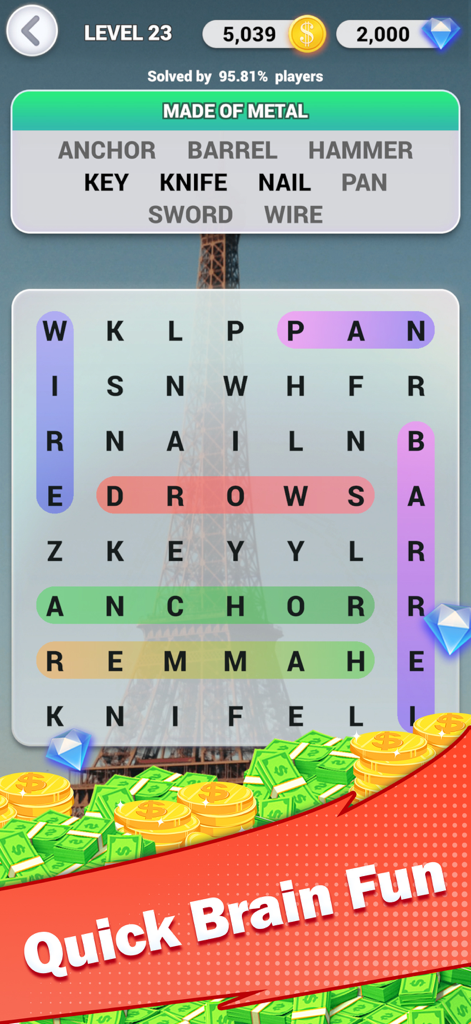 Écran de jeu du puzzle Words Explorer montrant une grille de mots mêlés sur un fond de Tour Eiffel.