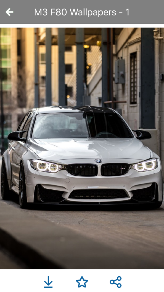 Front view of a white BMW M3 F80 parked in an urban alleyway