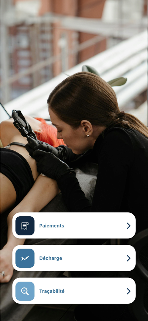 Tattoomorrow - Tattoo artist working on a client with Tattoomorrow app menu options for payments, disclaimers, and traceability.