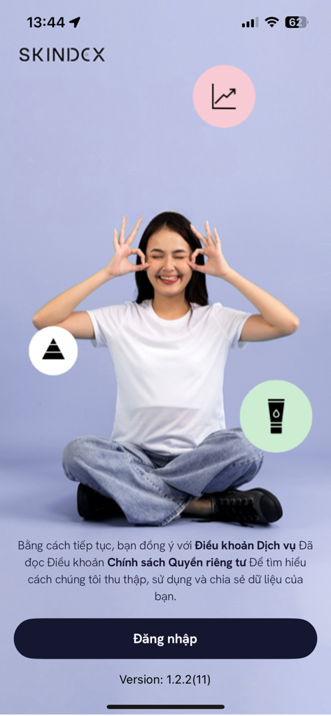 Login screen of the Skindex AI skincare app featuring a woman and tracking icons