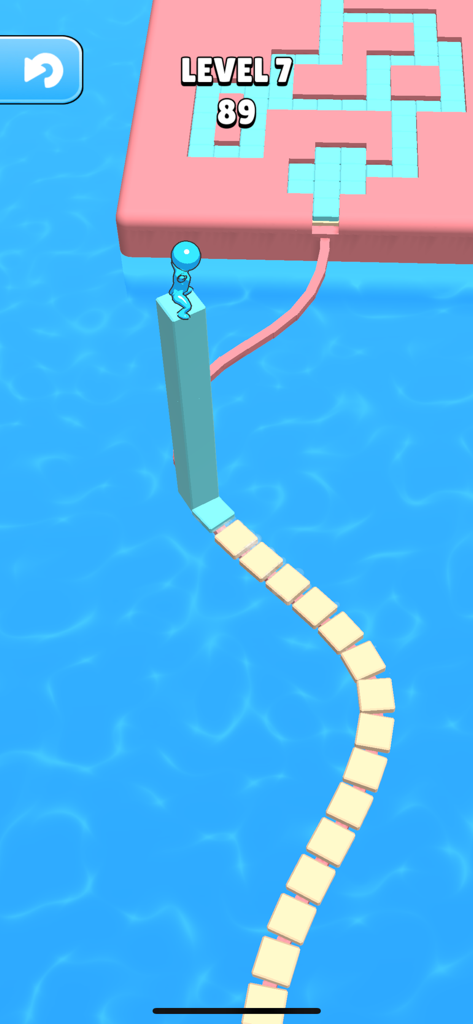 A blue character standing on a tall stack of tiles over water in the game Stacky Dash