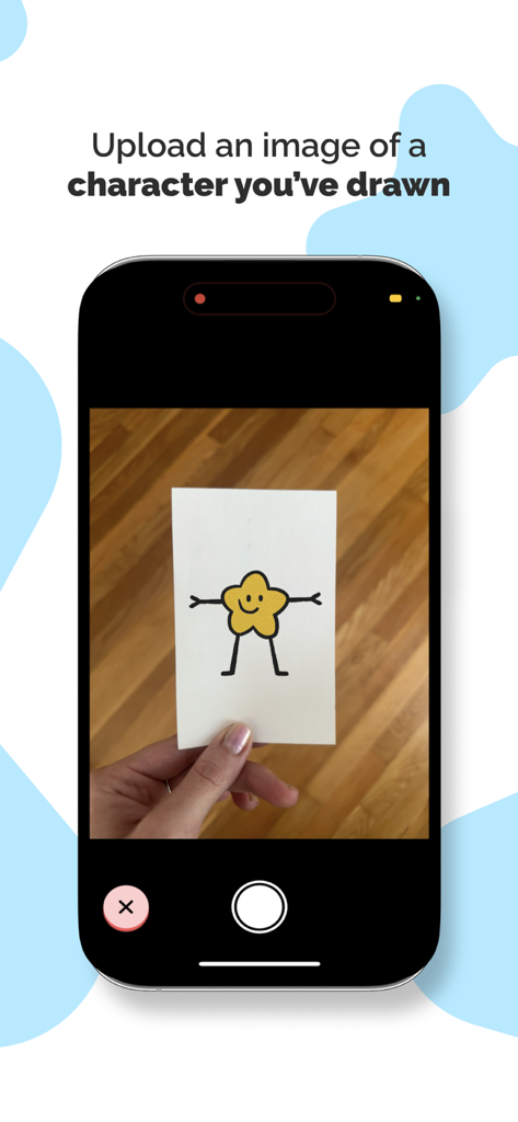A person using the AniMagic app to photograph a hand drawn star character on paper for animation