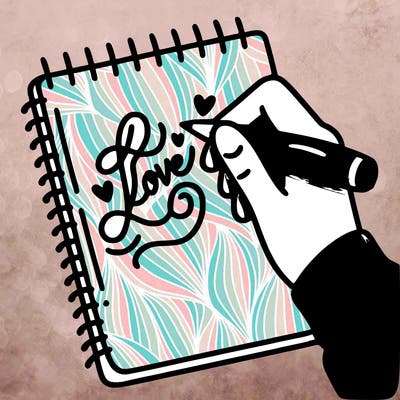 a hand writing “love” in calligraphy on a notebook