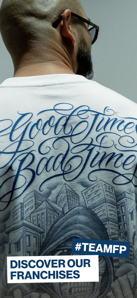 Man wearing a white t-shirt with a blue urban graphic and Footpatrol branding