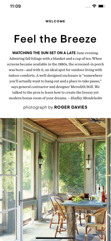 Elegant screened-in porch with outdoor dining area and lush green view