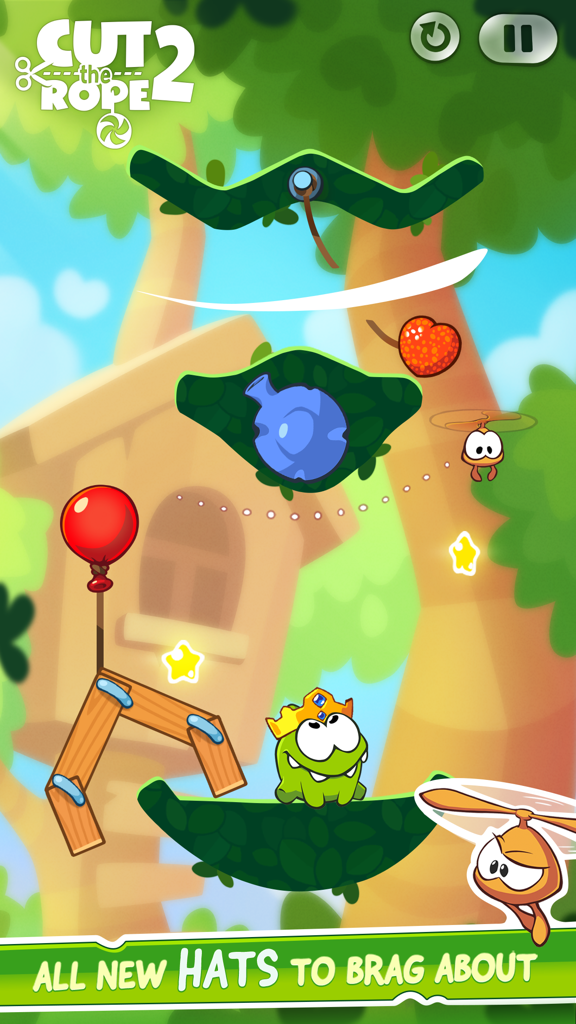 Cut the Rope 2 - Om Nom luciendo una corona dorada en un colorido nivel de Cut the Rope 2