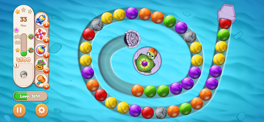 Gameplay of Marble Woka Woka showing a spiral of colored marbles and the turtle shooter on a water background