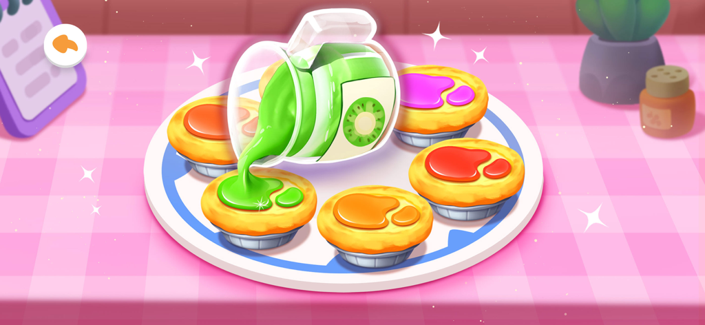 Panda Bake Cake Shop - 子供のゲーム画面で、バーチャルベーカリーでタルトに緑のキウイソースがかけられている様子