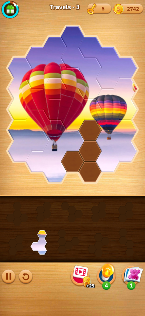 Jogabilidade de quebra-cabeça hexagonal apresentando uma imagem colorida de um balão de ar quente