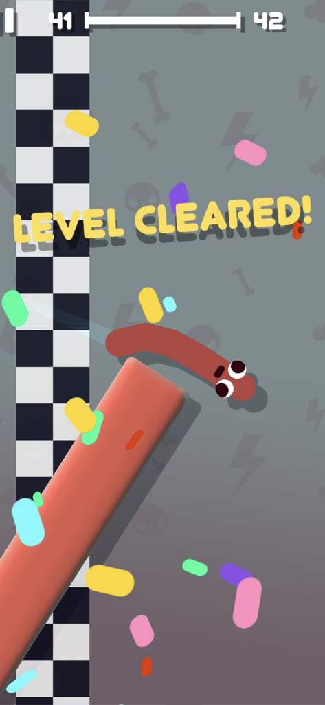 Sausage Flip game screen showing level cleared with a sausage character and colorful confetti.