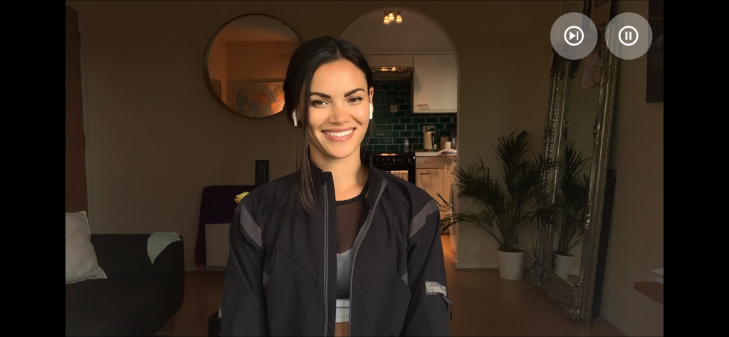 A woman smiling during a video call date in the Five Dates app