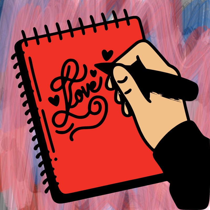 a hand writing “love” in calligraphy on a notebook