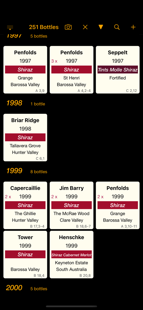 Personal Wine Cellar Database app showing a list of wine bottles organized by vintage year with storage locations.