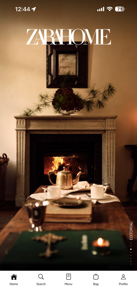 Zara Home - Acogedora sala de estar interior con una chimenea encendida y un elegante juego de té de la sección editorial de la app Zara Home