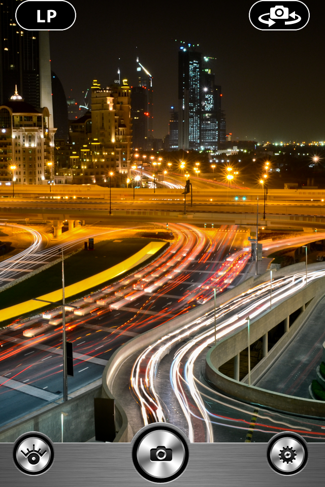 Camera<> - Slow Shutter Vintage Photo Camera 8mm - A slow shutter camera app interface showing vibrant light trails from traffic in a night city