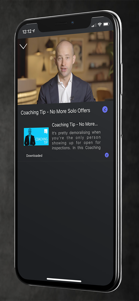 Smartphone screen showing a real estate coaching video tip on the Josh Phegan Digital app.