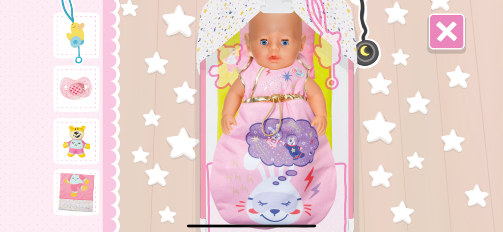 BABY born® - A BABY born doll tucked into a pink sleeping bag with a bunny design lying in a starry bed within the app interface.