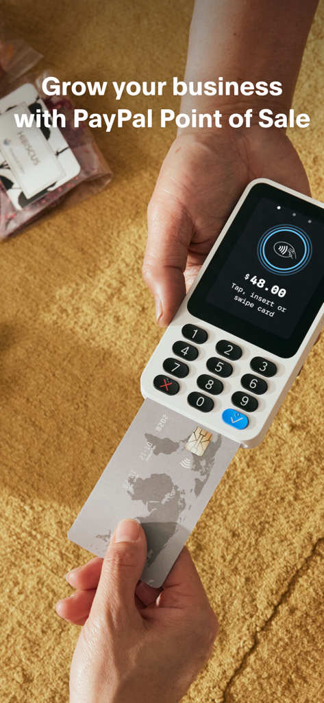 A merchant processing a credit card payment using the PayPal POS handheld card reader