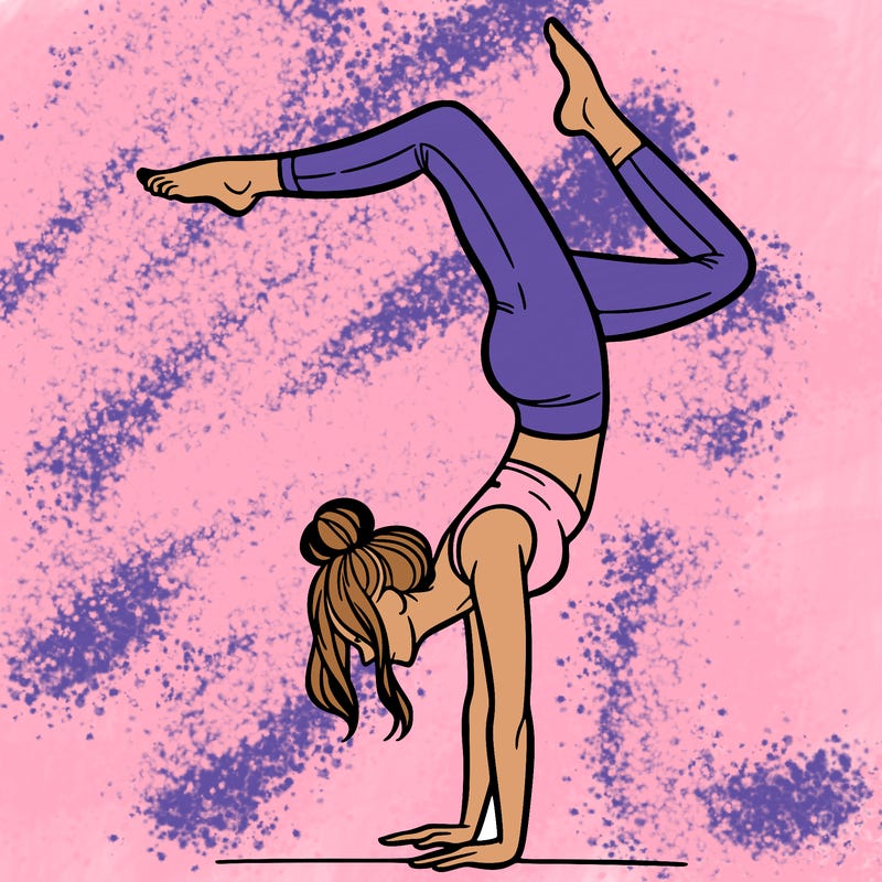 a woman doing a handstand