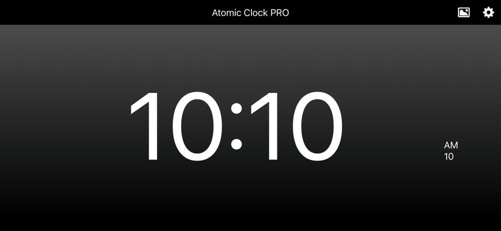 Atomic Clock PRO - Atomic Clock PRO digital display in landscape mode on a dark gradient background