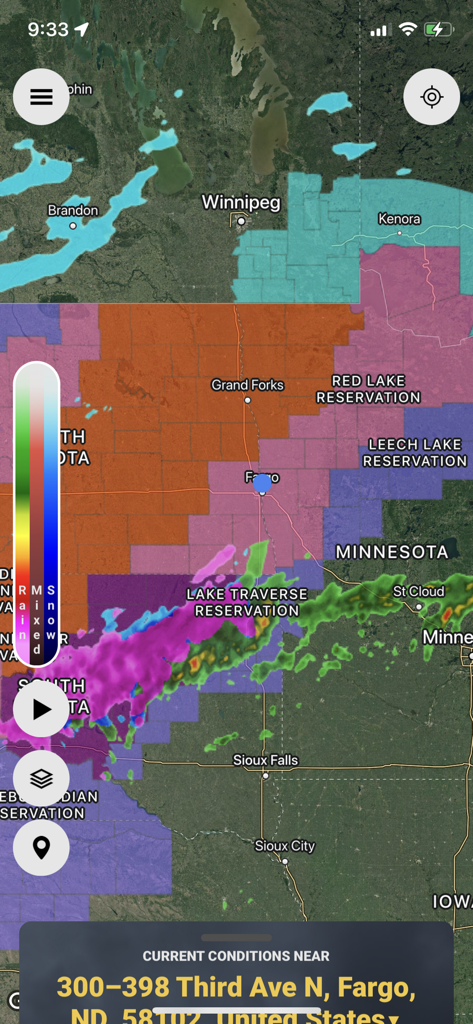 StormWatch plus mobile app interface showing a live weather radar map with rain and snow alerts over Fargo North Dakota