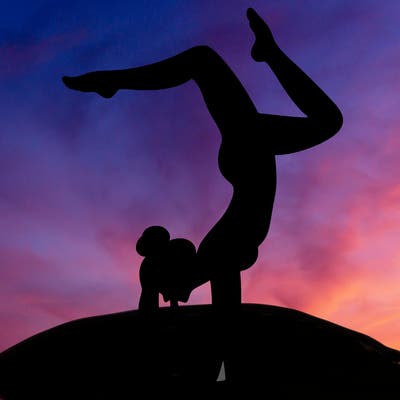 a woman doing a handstand