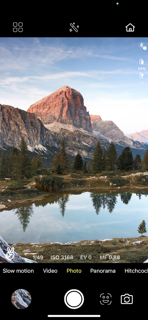 IZI GO - IZI GO app camera interface in photo mode capturing a mountain landscape with manual settings