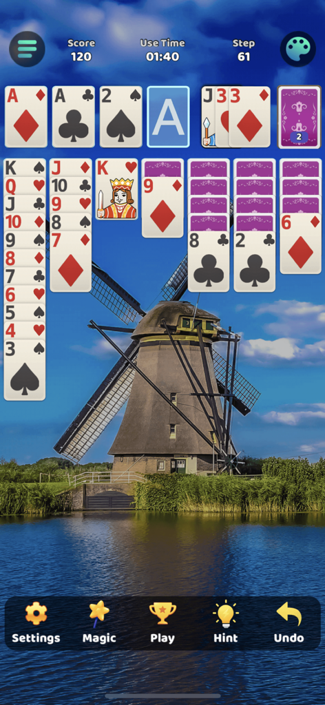 Classic Solitaire Klondike card game with a scenic windmill background