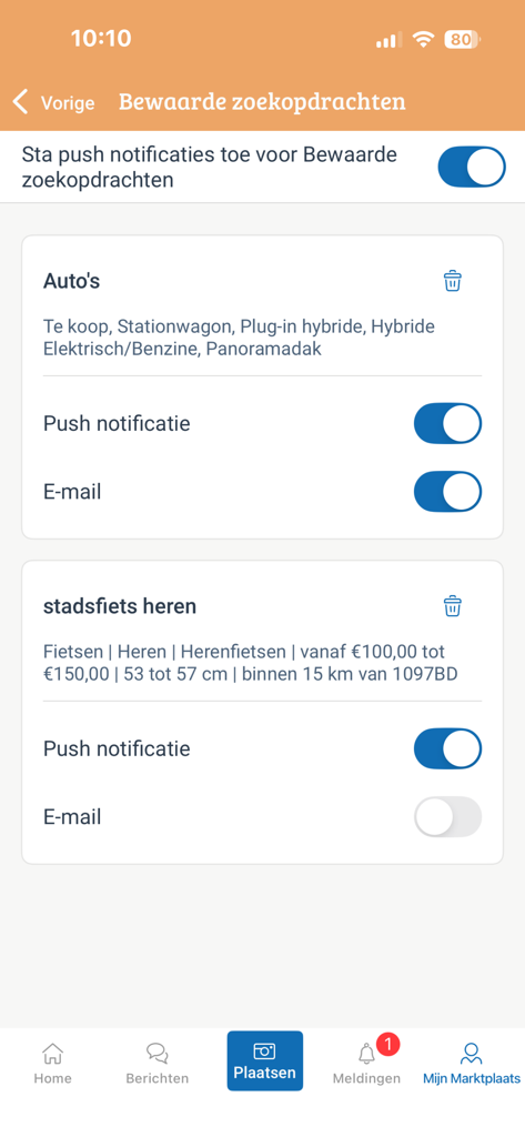 A screen in the Marktplaats app showing saved searches for cars and men's city bikes with push notification and email toggles.