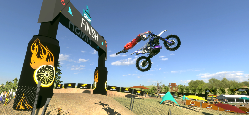 A dirt bike rider performing a mid-air stunt over a finish line in a 3D motocross game.