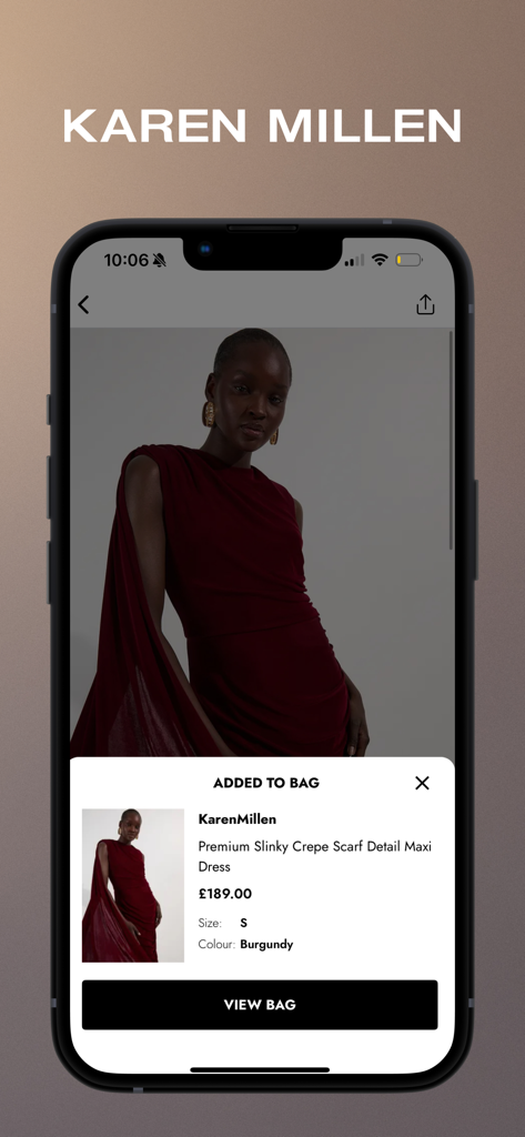 Karen Millen -Women’s Clothing - The Karen Millen app interface showing a burgundy maxi dress successfully added to the shopping bag.