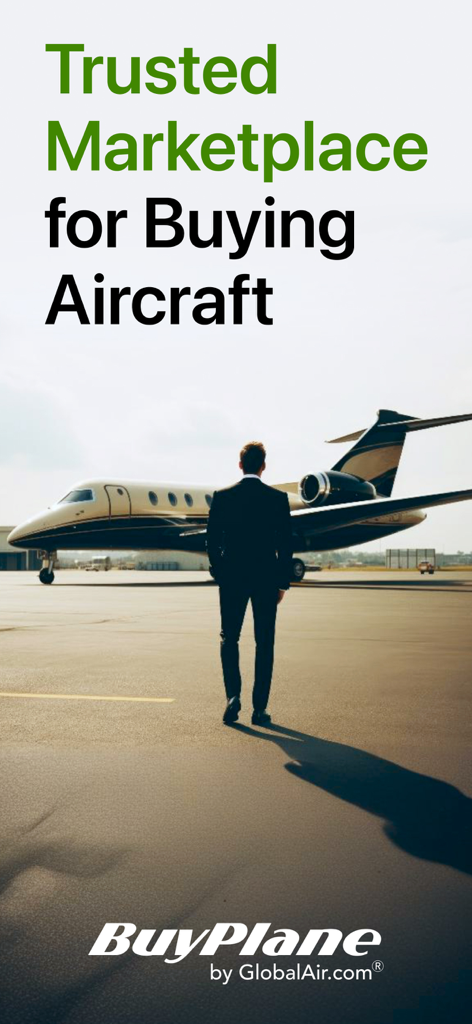 A man in a suit standing on a runway looking at a private jet aircraft