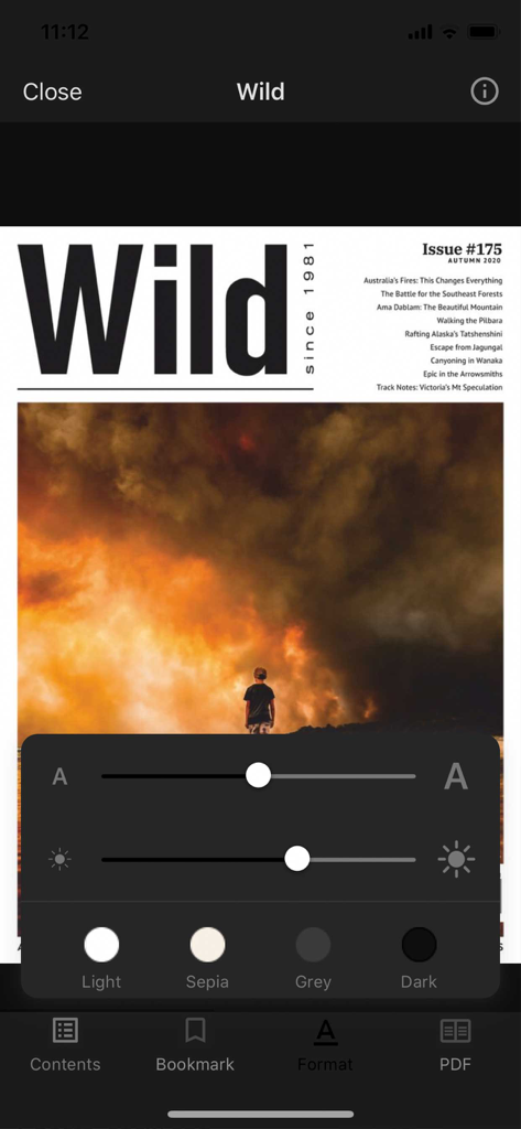 Interface of the Wild magazine app showing reading format options for text size, brightness, and background color themes over a digital issue cover.