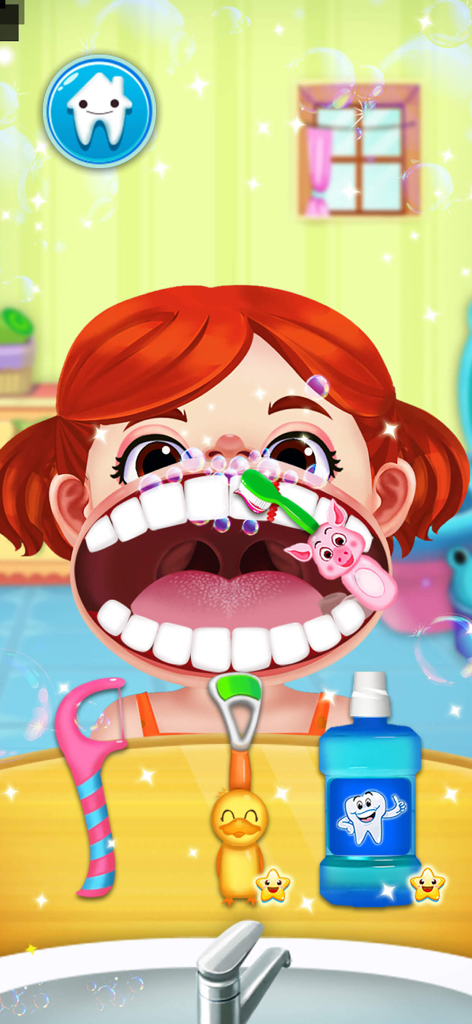 A child patient in a dental simulator game having her teeth brushed with a pig shaped toothbrush